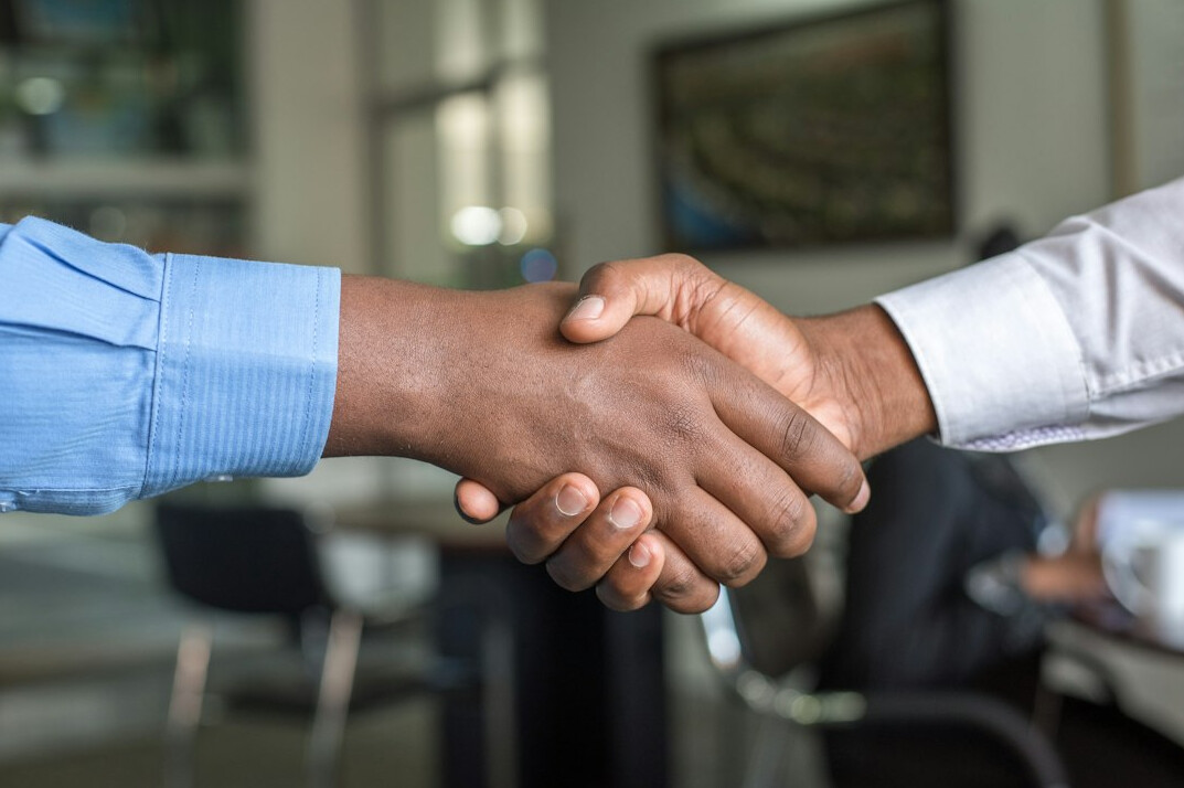 business people shaking hands in meeting